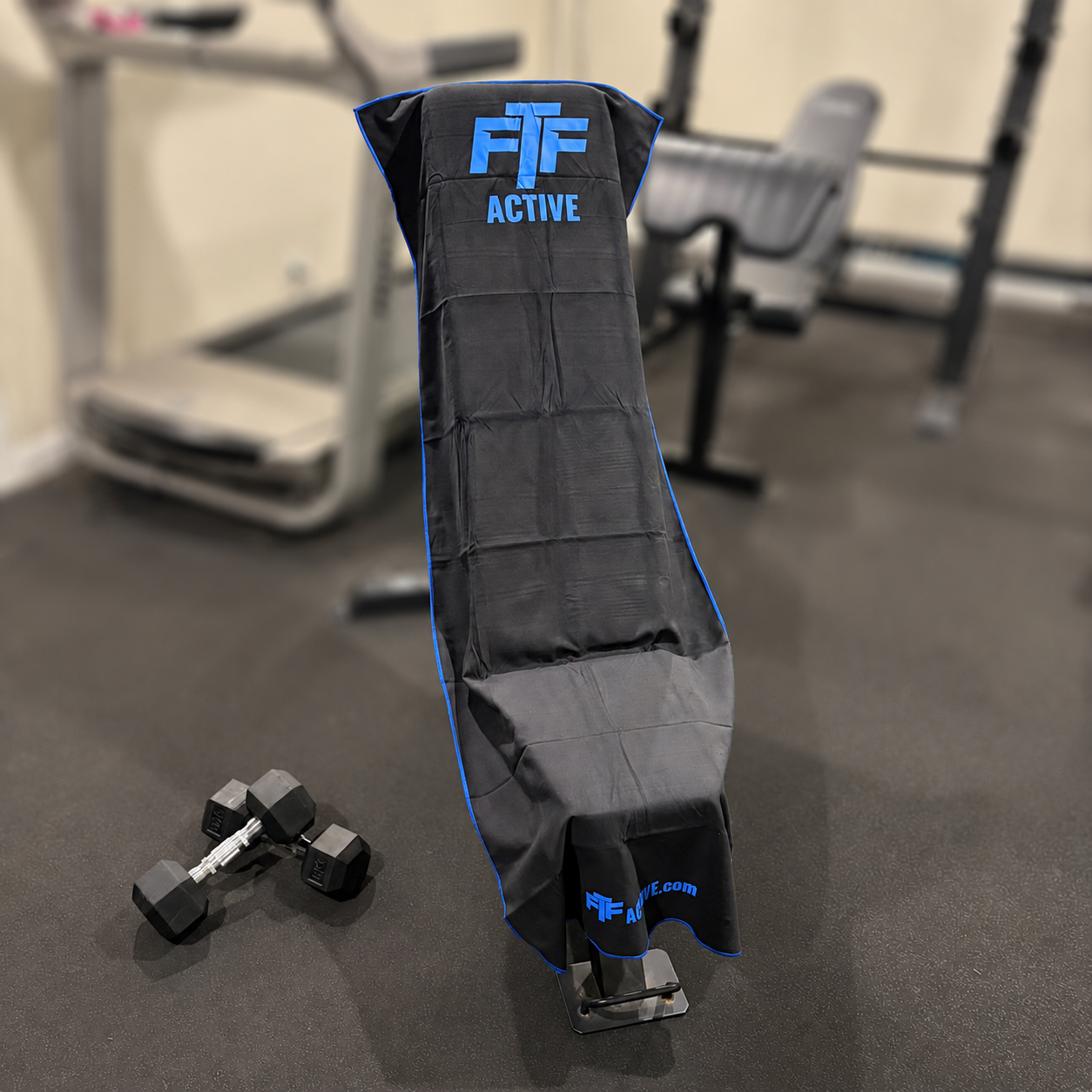 Black & Blue BenchLock Hooded Gym Towel securely held in place on incline bench 