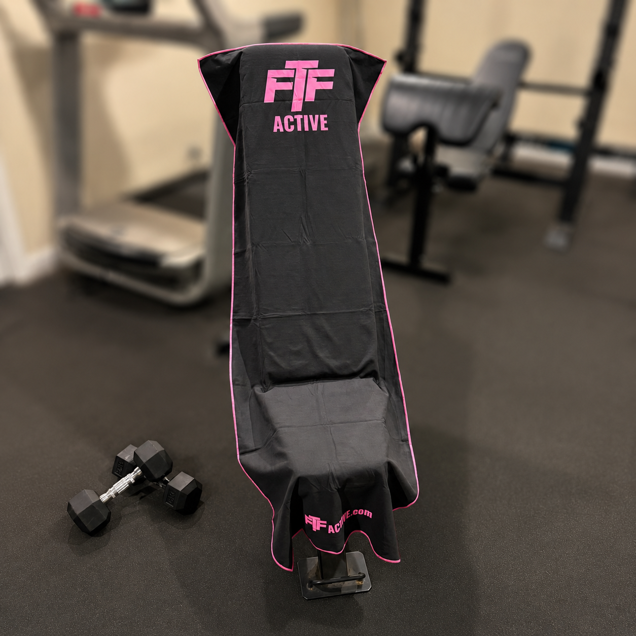 Black & Pink BenchLock Hooded Gym Towel securely held in place on incline bench 