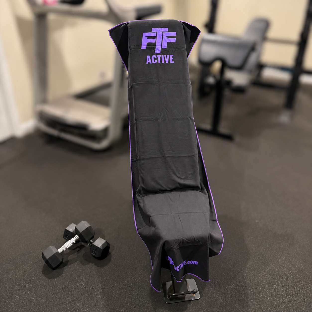 Black & Purple BenchLock Hooded Gym Towel securely held in place on incline bench 