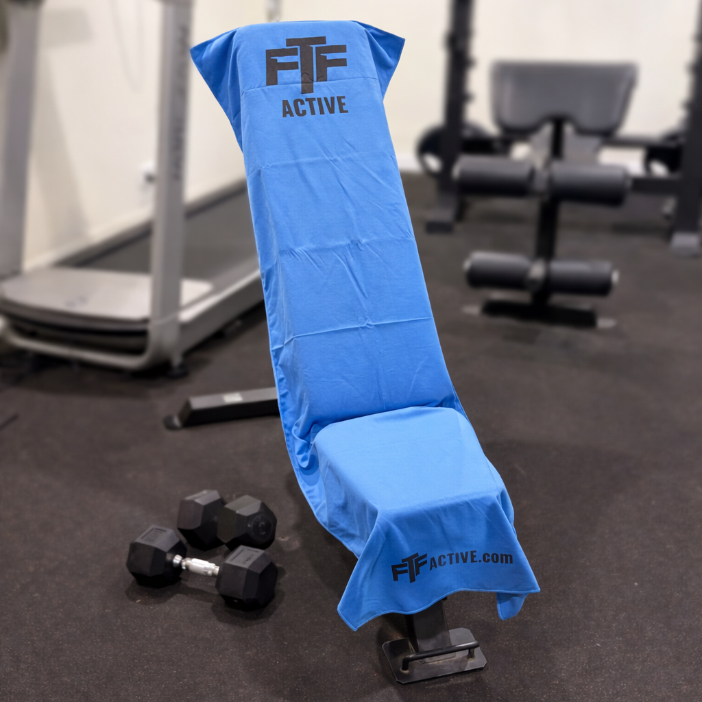 Blue BenchLock Hooded Gym Towel securely held in place on incline bench 