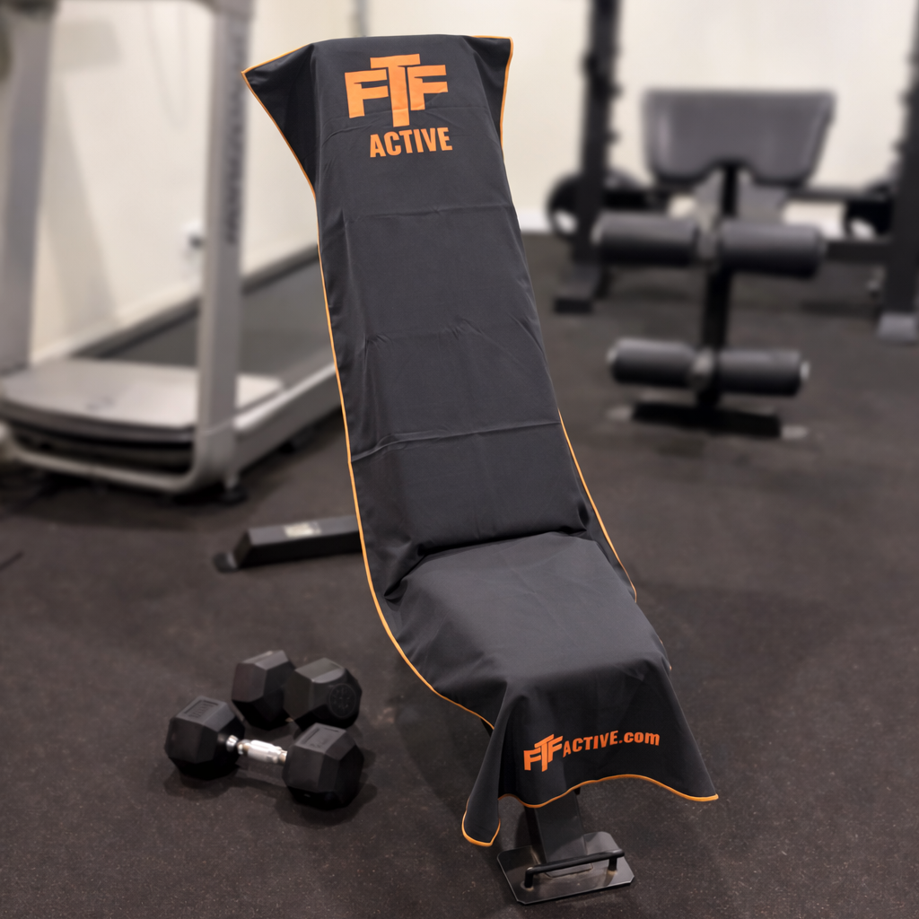 Black & Orange BenchLock Hooded Gym Towel securely held in place on incline bench 