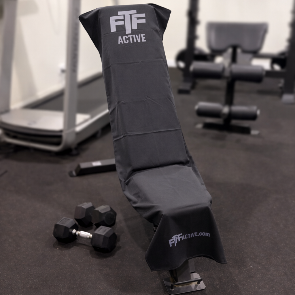 Black BenchLock Hooded Gym Towel securely held in place on incline bench 