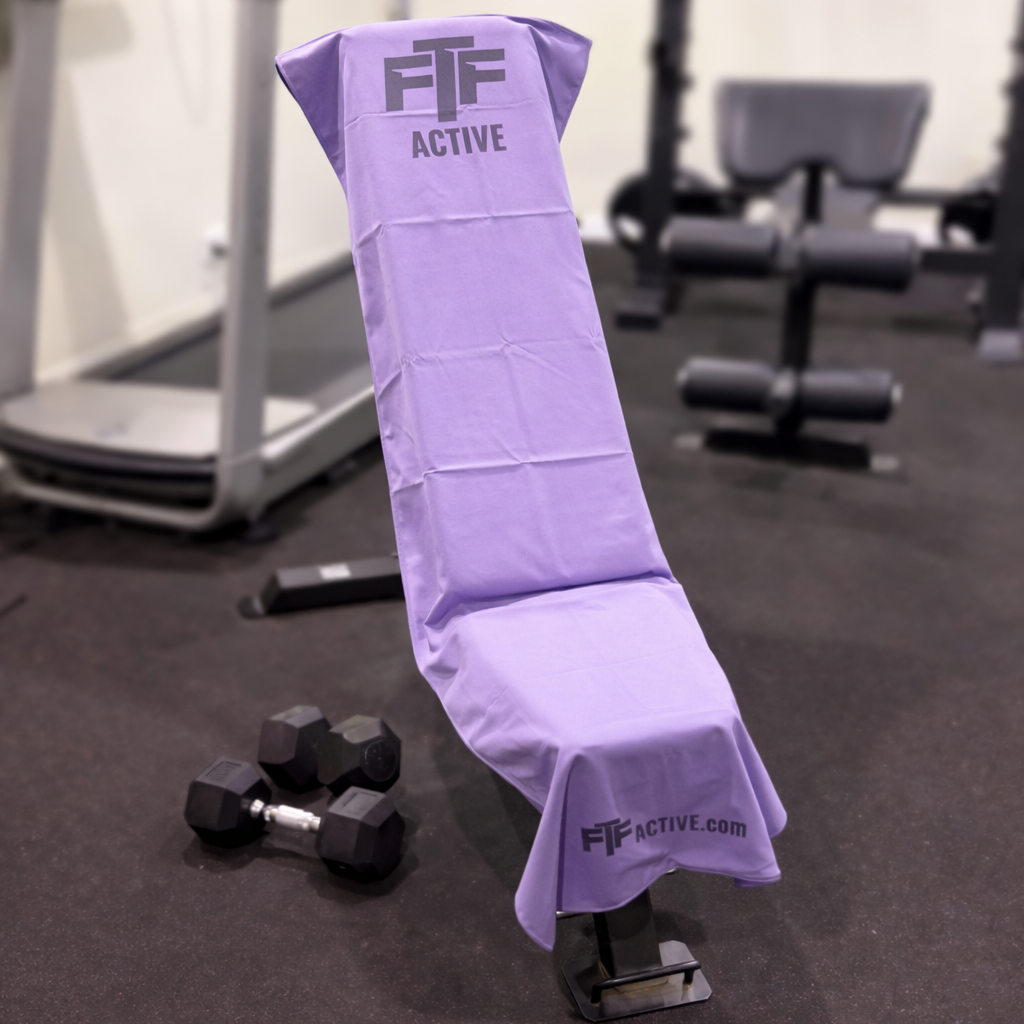 Purple BenchLock Hooded Gym Towel securely held in place on incline bench 